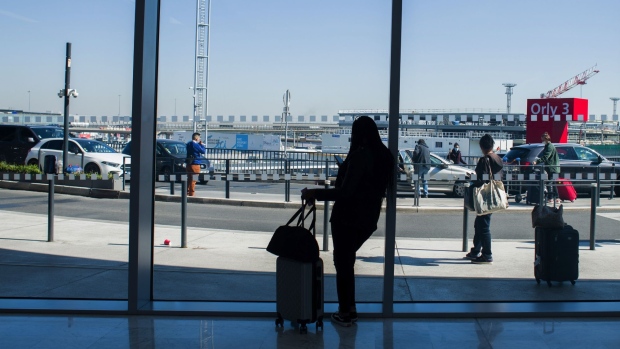 A traveler uses a smartphone in Terminal 3 of Orly Airport, operated by Aeroports de Paris, in Paris, France, on Tuesday, April 27, 2021. France is moving toward a broad rollout of digital health certificates, putting the country at the forefront of a European Union push for vaccine passports to jumpstart travel. Photographer: Nathan Laine/Bloomberg