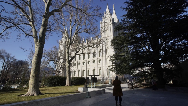 SALT LAKE CITY, UT - DECEMBER 17: A woman takes a picture of The Church of Jesus Christ of Latter-Day Saints, historic Mormon Salt Lake Temple on December 17, 2019 in Salt Lake City, Utah. A inside whistle blower has alleged the Mormon Church misled members on how a $100 billion investment fund was used. (Photo by George Frey/Getty Images) Photographer: George Frey/Getty Images North America