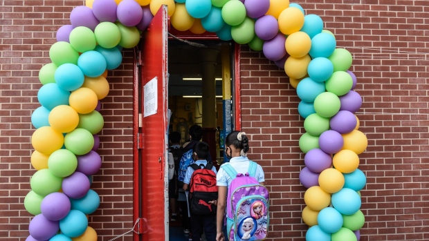 Students arrive on the first classes at a public school in the Bronx borough in New York on Sept. 13. Photographer: Stephanie Keith/Bloomberg