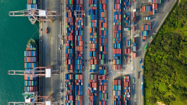 Container ships are docked as shipping containers sit in the Busan Port Terminal (BPT) in this aerial photograph taken in Busan, South Korea, on Tuesday, Oct. 13, 2020. South Korea�s central bank left its key interest rate unchanged on Wednesday amid signs that a resurgence of the coronavirus at home is waning and exports and inflation are picking up. Photographer: SeongJoon Cho/Bloomberg