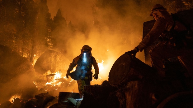 Firefighters attempt to protect a home near Santa Claus Drive during the Caldor Fire near Meyers, California, on Aug. 31, 2021.