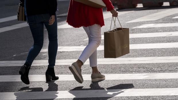 A pedestrian carries a shopping bag in San Francisco, California, U.S., on Thursday, Sept. 16, 2021. Prices paid by U.S. consumers rose in August by less than forecast, snapping a string of hefty gains and suggesting that some of the upward pressure on inflation is beginning to wane. Photographer: David Paul Morris/Bloomberg