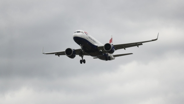 A passenger aircraft, operated by British Airways, a unit of International Consolidated Airlines Group SA (IAG) lands at London Heathrow Airport in London, U.K., on Monday, June 8, 2020. The U.K. is pressing ahead with a two-week quarantine on international arrivals, a move British Airways and other carriers say will devastate tourism and wreck any chance the summer holiday season could spark a recovery from a virus-induced slump. Photographer: Simon Dawson/Bloomberg