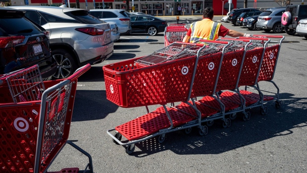 A worker collects shopping carts from the parking lot of a Target Corp. store in Emeryville, California, U.S., on Monday, March 1, 2021. Target Corp. is scheduled to release earnings figures on March 2.