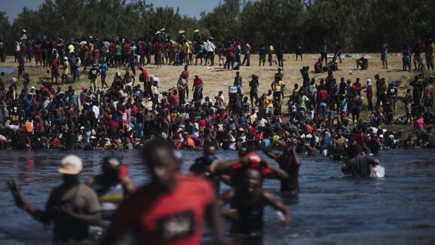 Migrants cross the Rio Grande River near the Del Rio-Acuna Port of Entry in Ciudad Acuna, Coahuila state, Mexico, on Sept. 19.