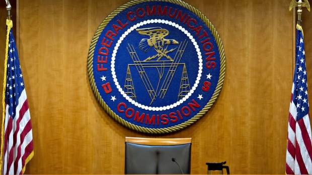 The Federal Communications Commission (FCC) seal hangs inside a meeting room at the headquarters ahead of a open commission meeting in Washington, D.C., U.S., on Thursday, Dec. 14, 2017. The FCC is slated to vote to roll back a 2015 utility-style classification of broadband and a raft of related net neutrality rules, including bans on broadband providers blocking and slowing lawful internet traffic on its way to consumers.