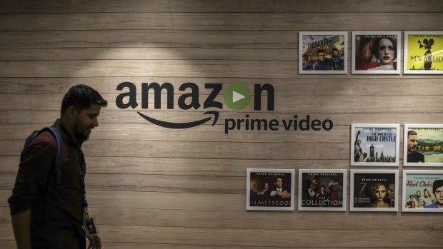 An employee walks past a wall display for Amazon.com Inc.'s Prime Video streaming service at the company's office campus in Hyderabad, India, on Friday, Sept. 6, 2019. Amazon's only company-owned campus outside the U.S. opened at the end of August on the other side of the globe, thousands of miles from their Seattle headquarters. The 15-storey building towers over the landscape in Hyderabad's technology and financial district, signaling the giant online retailer's ambitions to expand in one of the world's fastest-growing retail markets.