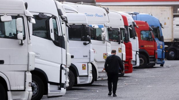 A driver passes a row of trucks at a service station near Thurrock, U.K., on Friday, Sept. 3, 2021. The U.K. is running out of time to find more truck drivers before isolated incidents at supermarkets and fast-food chains erupt into a deeper crisis that leaves businesses crippled by delivery delays and shortages. Photographer: Chris Ratcliffe/Bloomberg