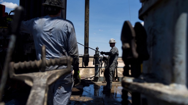 Contractors operate a drilling pipe at a Colgate Energy LLC oil rig in Reeves County, Texas, U.S., on Wednesday, Aug. 22, 2018. Spending on water management in the Permian Basin is likely to nearly double to more than $22 billion in just five years, according to industry consultant IHS Markit.