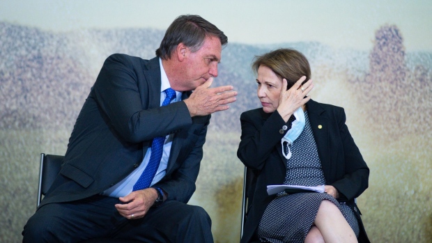 Jair Bolsonaro, Brazil's president, speaks to Tereza Cristina, Brazil's agriculture minister, during the launch event of the Banco do Brasil SA Agro Investment Program at Planalto Palace in Brasilia, Brazil, on Tuesday, Aug. 24, 2021. Bolsonaro is growing uneasy about Brazil’s inflation in the run-up to general elections next year, but his complaints about rising prices don’t mean he plans to interfere with the central bank, according to five people close to him including cabinet members.