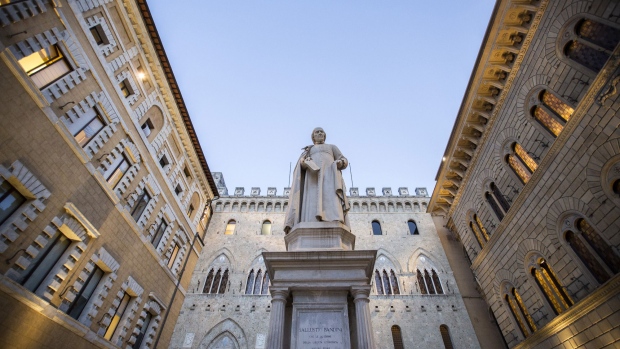 The statue of Sallustio Bandini, an economist and politician, stands in Piazza Salimbeni in front of the Monte dei Paschi di Siena SpA bank headquarters in Siena, Italy, on Friday, Dec. 16, 2016. The bank will begin taking orders for shares Monday as it aims to complete raising 5 billion euros ($5.2 billion) by the end of the year to avoid a rescue by the Italian government.