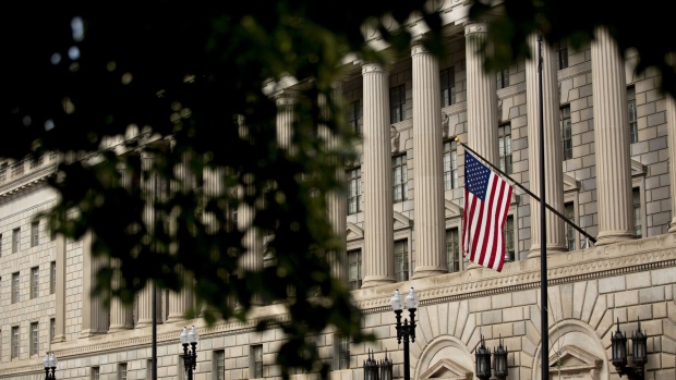 An American flag flies outside the U.S. Department of Commerce headquarters in Washington, D.C., U.S., on Friday, June 1, 2018. The Trump administration this week announced it is imposing tariffs on steel and aluminum imported from the European Union, Canada and Mexico to help protect America's manufacturing base the Commerce secretary said. Photographer: Andrew Harrer/Bloomberg