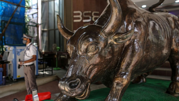 A bronze bull statue stands at the entrance to the Bombay Stock Exchange (BSE) building in Mumbai, India, on Wednesday, May 26, 2021. Money managers are counting on a consumption-led economic rebound from the world's worst coronavirus outbreak and the nation's long-term growth prospects to support corporate earnings and equity valuations. Photographer: Dhiraj Singh/Bloomberg
