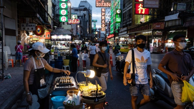 Pedestrians walk past street food stands at Yaowarat Road in the Chinatown area of Bangkok, Thailand, on Wednesday, May 26, 2021. It could take another five years before tourism revives fully in Thailand -- which closed its borders to most foreign visitors in March 2020 -- an ominous sign for one of the most travel-dependent economies in the world. Photographer: Luke Duggleby/Bloomberg
