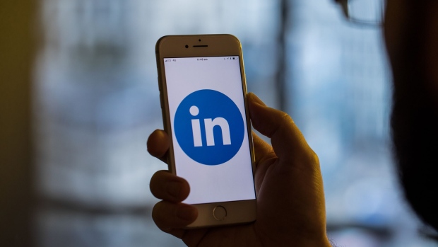 The logo for Linkedin Corp., a unit of Microsoft Corp., sits on an Apple iPhone smartphone in this arranged photograph in London, U.K., on Monday, Aug. 20, 2018. The NYSE FANG+ Index is an equal-dollar weighted index designed to represent a segment of the technology and consumer discretionary sectors consisting of highly-traded growth stocks of technology and tech-enabled companies. Photographer: Jason Alden/Bloomberg