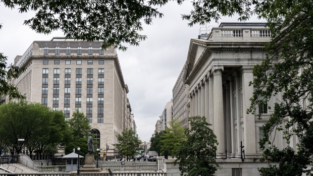 The U.S. Treasury Department building, right, in Washington, D.C., U.S., on Friday, July 2, 2021. The Biden administration and global allies scored a major victory yesterday in their push for a more balanced international corporate tax system, but still face multiple significant obstacles to completing an ambitious plan that has been years in the making. Photographer: Joshua Roberts/Bloomberg