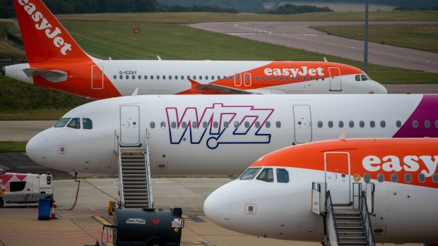 Passenger aircraft, operated by EasyJet Plc and Wizz Air Holdings Plc, on the tarmac at London Luton Airport Ltd. in Luton, U.K., on Thursday, Sept. 9, 2021. EasyJet rejected an unsolicited takeover approach from rival discounter Wizz Air, according to people familiar with the matter, and said it will raise $2 billion in stock and debt instead. Photographer: Chris J. Ratcliffe/Bloomberg