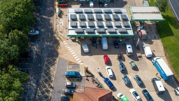 Cars queue up to use the fuel pumps at BP Plc petrol station near Guildford, U.K., on Monday, Sept. 27, 2021. The U.K. government took emergency measures late Sunday to try to ease acute fuel shortages across the country, as gasoline retailers shut pumps after days of panic buying.