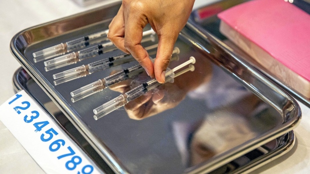 A nurse places a syringes containing doses of the AstraZeneca Covid-19 vaccine on a tray at the Bamrasnaradura Infectious Diseases Institute in Nonthaburi, Thailand, on Friday, March 12, 2021. Thailands Health Ministry said that the nation would temporarily halt the use of AstraZeneca Plc vaccines until theres more clarity from the investigations of possible blood clots. The Prime Minister Prayuth Chan-Ocha and some of his cabinet members who were scheduled to get their AstraZeneca shots today have postponed their appointments after suspensions of the vaccine in some European countries, including in Denmark, Italy and Norway. Photographer: Bloomberg/Bloomberg