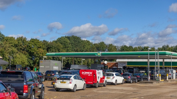 Cars queue up to use the fuel pumps at BP Plc petrol station near Guildford, U.K., on Monday, Sept. 27, 2021. The U.K. government took emergency measures late Sunday to try to ease acute fuel shortages across the country, as gasoline retailers shut pumps after days of panic buying.