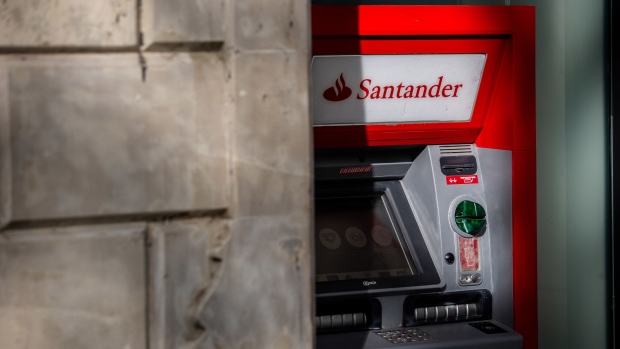 An automated teller machine (ATM) outside a Banco Santander SA bank branch in Barcelona, Spain, on Saturday, July 24, 2021. Santander, Banco Bilbao Vizcaya Argentaria SA (BBVA) and Caixabank SA report earnings this week. Photographer: Angel Garcia/Bloomberg