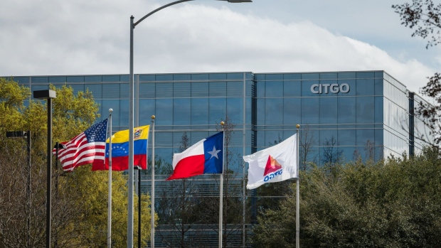 Flags fly outside Citgo Petroleum Corp. headquarters stands in Houston, Texas, U.S., on Thursday, Feb. 14, 2019. Interviews with current and former employees at headquarters and refineries reveal a company at a turning point. Citgo is free for the moment from political interference, cronyism and corruption, but lacks leaders to chart a path forward. Photographer: Loren Elliot/Bloomberg