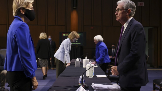Senator Elizabeth Warren, a Democrat from Massachusetts, left, speaks with Jerome Powell, chairman of the U.S. Federal Reserve, during a Senate Banking, Housing and Urban Affairs Committee hearing in Washington, D.C., U.S., on Tuesday, Sept. 28, 2021. The Treasury secretary today warned that her department will effectively run out of cash around Oct. 18 unless legislative action is taken to suspend or increase the federal debt limit, putting pressure on lawmakers to avert a default on U.S. obligations.