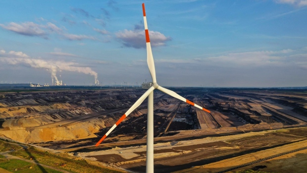 A wind turbine beside the Garzweiler lignite mine, operated by RWE AG, in Rheinisches Revier, Germany, on Wednesday, Aug. 11, 2021. A report from the world’s top climate scientists warned that the planet will warm by 1.5° Celsius in the next two decades without drastic moves to eliminate greenhouse gas pollution. Photographer: Alex Kraus/Bloomberg