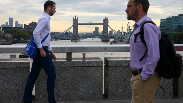 Morning commuters cross London Bridge in London, U.K., on Monday, Sept. 13, 2021. The ending of the government's furlough scheme in September will be key to the outlook for jobs and interest rates. Photographer: Hollie Adams/Bloomberg