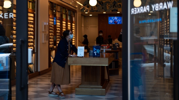 A employee helps customers at a Warby Parker Retail Inc. store in Philadelphia, Pennsylvania, U.S., on Thursday, Aug. 12, 2021. The City of Philadelphia issued new mask mandates to protect against the Delta variant, requiring masks to be worn indoors and at large outdoor gatherings. Photographer: Kriston Jae Bethel/Bloomberg