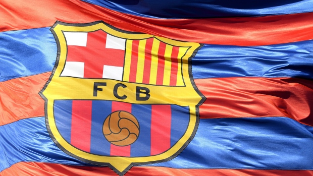 BARCELONA, SPAIN - APRIL 04: The Barcelona logo is seen on a flag waving above the stadium prior to the UEFA Champions League Quarter Final Leg One match between FC Barcelona and AS Roma at Camp Nou on April 4, 2018 in Barcelona, Spain. 
