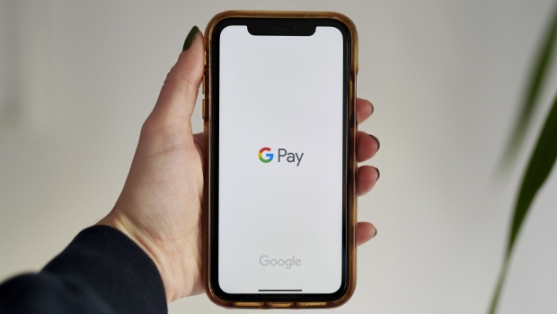 Google Pay signage on a smartphone in the Brooklyn Borough of New York, U.S., on Thursday, Nov. 19, 2020. Alphabet Inc. unveiled its long-anticipated expansion of Google Pay, partnering with banks and retailers to offer consumers new forms of bank accounts, cards and discounts. Photographer: Gabby Jones/Bloomberg