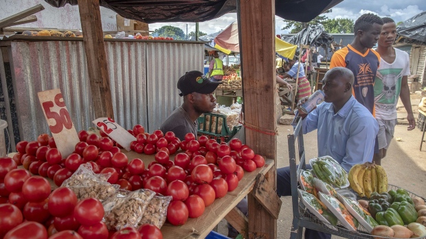 A vendor sits by his fresh fruit and vegetable stall as he waits for customers at a market in Harare, Zimbabwe, on Thursday, Jan. 17, 2019. Hopes of an economic revival in Zimbabwe lie in tatters 14 months after President Emmerson Mnangagwa took office, as the nation reels from foreign-exchange and fuel shortages, strikes and a dearth of political leadership. Photographer: Bloomberg/Bloomberg