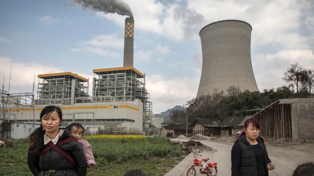 LIUZHI COUNTY, CHINA - FEBRUARY 7: Chinese villagers stand near a newly built state-owned coal fired power plant on February 7, 2017 in Liuzhi County, Guizhou province, southern China. A history of heavy dependence on burning coal for energy has made China the source of nearly a third of the world's total carbon dioxide (CO2) emissions, the toxic pollutants widely cited by scientists and environmentalists as the primary cause of global warming. China's government has fast-tracked deadlines to reach the country's emissions peak, and data suggest the country's coal consumption is already in decline. (Photo by Kevin Frayer/Getty Images)