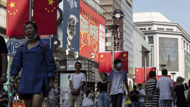 Shoppers and visitors walk along Nanjing Road East in Shanghai, China, on Sunday, Oct. 3, 2021. China contained its latest Covid-19 outbreak just in time for a week-long holiday that started on Oct. 1, avoiding the need for travel curbs during a crucial period of consumer spending and domestic tourism.