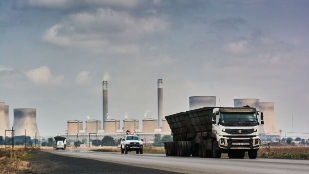 A truck passes the Kendal coal-fired power station, operated by Eskom Holdings SOC Ltd., in Mpumalanga, South Africa, on Thursday, Sept. 30, 2021. South Africa is under pressure to cut its dependence on coal -- which accounts for more than 80% of its power generation – but it needs finance to facilitate the transition to cleaner energy. Photographer: Waldo Swiegers/Bloomberg