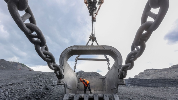 A worker inspects a giant crane bucket at the Krasnogorsky open pit coal mine, operated by Mechel PJSC, in Mezhdurechensk, Russia, on Monday, July 19, 2021. Russia’s government is betting that coal consumption will continue to rise in big Asian markets like China even as it dries up elsewhere.