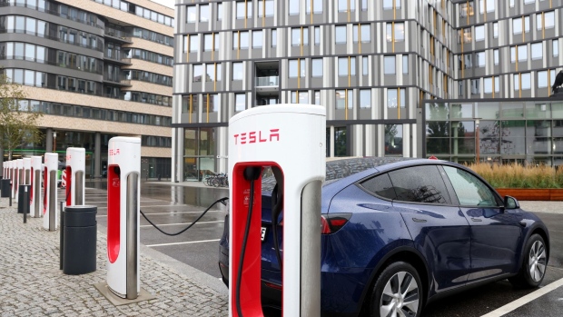 A Model Y electric sports utility vehicle recharging at a supercharger station in central Berlin. Photographer: Liesa Johannssen-Koppitz/Bloomberg