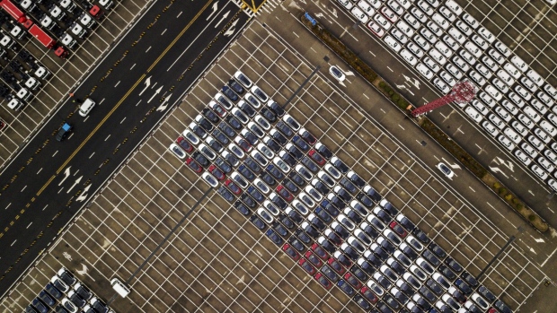 Tesla vehicles, center, parked at a port in Shanghai. Photographer: Qilai Shen/Bloomberg