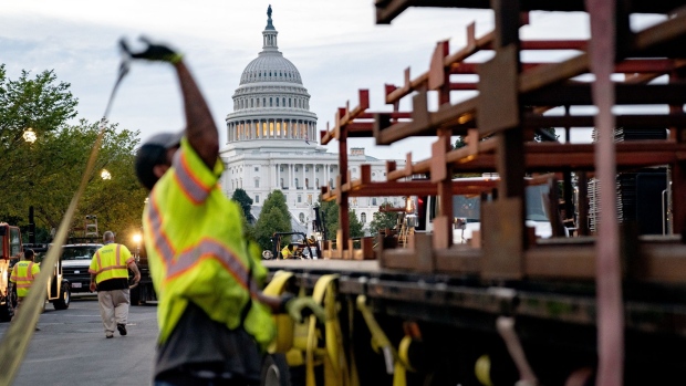 A worker secures security fencing on a truck ahead of a planned "Justice for J6" rally outside the U.S. Capitol in Washington, D.C., U.S., on Thursday, Sept. 16, 2021. A demonstration this Saturday in support of people arrested in the Jan. 6 insurrection has prompted security officials to warn members of Congress and their staffs to stay away from the Capitol on that day. Photographer: Stefani Reynolds/Bloomberg