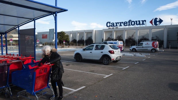 A customer collects a shopping cart outside a Carrefour SA hypermarket in Avignon, France, on Friday, Jan. 15, 2021. Alimentation Couche-Tard Inc. plans to pump 3 billion euros ($3.6 billion) into Carrefour as the Canadian convenience-store operator seeks to defuse mounting French political concerns over the proposed $20 billion takeover of the French retailer. Photographer: Jeremy Suyker/Bloomberg