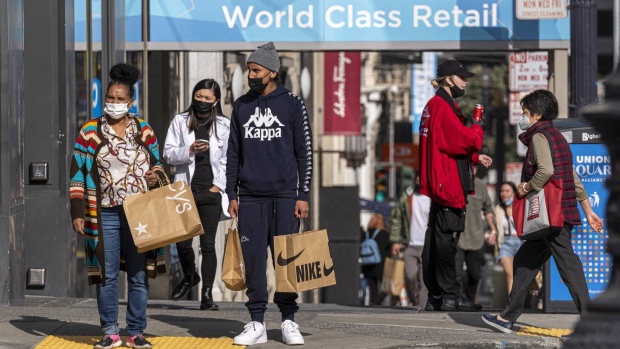 Pedestrians carry shopping bags in San Francisco, California, U.S., on Thursday, Sept. 16, 2021. Prices paid by U.S. consumers rose in August by less than forecast, snapping a string of hefty gains and suggesting that some of the upward pressure on inflation is beginning to wane. Photographer: David Paul Morris/Bloomberg