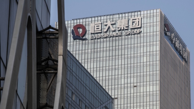 The China Evergrande Group logo displayed atop the company's headquarters in Shenzhen, China, on Thursday, Sept. 30, 2021. China Evergrande Group started returning a small portion of the money owed to buyers of its investment products, weeks after people protested against missed payments. Photographer: Gilles Sabrie/Bloomberg