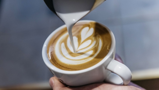 An employee pours a latte art into a cup of coffee at the Roastery Lab by Coffee Academics research and development facility, operated by Coffee Academics Group Holdings Ltd., in Hong Kong, China, on Thursday, July 27, 2017. Coffee Academics operates seven coffee outlets in Hong Kong. Photographer: Anthony Kwan/Bloomberg