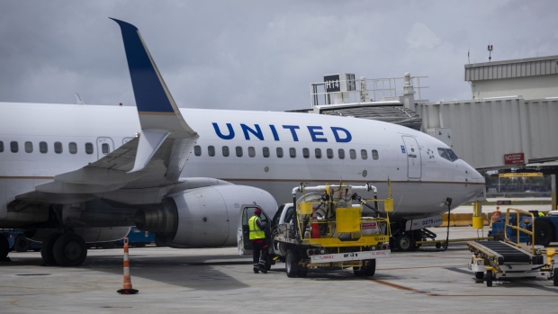 A passenger aircraft operated by United Airlines Holdings Inc. at Miami International Airport in Miami, Florida, U.S., on Wednesday, June 16, 2021. Daily U.S. air travelers exceeded 2 million for the first time since the coronavirus pandemic began, reaching almost three-quarters of the volume recorded on the same day in 2019, according to the Transportation Security Administration. Photographer: Eva Marie Uzcategui/Bloomberg