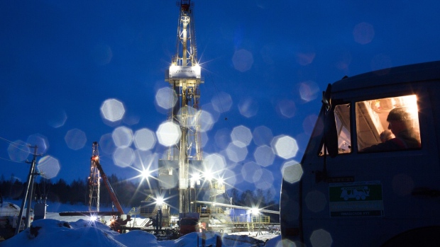 An oil drilling rig, operated by Tatneft PJSC, operates at night on an oilfield near Almetyevsk, Tatarstan, Russia, on Tuesday, March 6, 2019. Tatneft explores for, produces, refines, and markets crude oil.