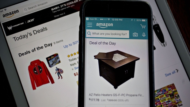 The Amazon.com Inc. application displays "Deals of the Day" on an Apple Inc. iPhone and iPad in Washington, D.C., U.S., on Monday, Dec. 5, 2016. Amazon.com unveiled a new security tool for cloud customers last week, part of a slew of product announcements designed to fend off competition from Microsoft Corp., Alphabet Inc.'s Google and others in the fast-growing cloud computing market. Photographer: Andrew Harrer/Bloomberg