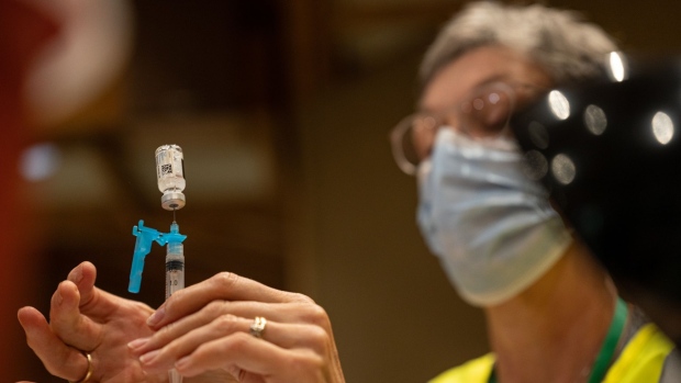 A healthcare worker fills a syringe with a dose of the Johnson & Johnson Covid-19 vaccine at a vaccination popup location inside the Louisville Zoo in Louisville, Kentucky, U.S., on Friday, Aug. 6, 2021. Vaccination rates across Kentucky’s 120 counties vary from as low as 21 percent to as high as 61 percent, according to data from the Centers for Disease Control and Prevention.