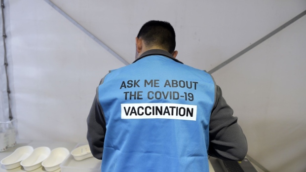 A pharmacist works at a drive-thru Covid-19 vaccination hub set up on the grounds of shutdown Bunnings Warehouse store in the Melton area of Melbourne, Australia, on Monday, Aug. 9, 2021. Australia continues its struggle to contain a delta outbreak across the nation's east coast, with the race to increase vaccinations now key to prospects for a reduction in virus restrictions.