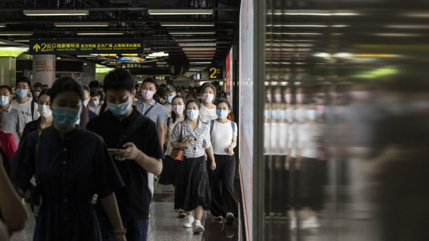 Commuters wearing protective masks make their way through a subway station during the morning rush hour in Shanghai, China, on Friday, Aug. 6, 2021. China is facing a delta-driven coronavirus resurgence that's grown to more than 500 cases scattered across half the country. Photographer: Qilai Shen/Bloomberg